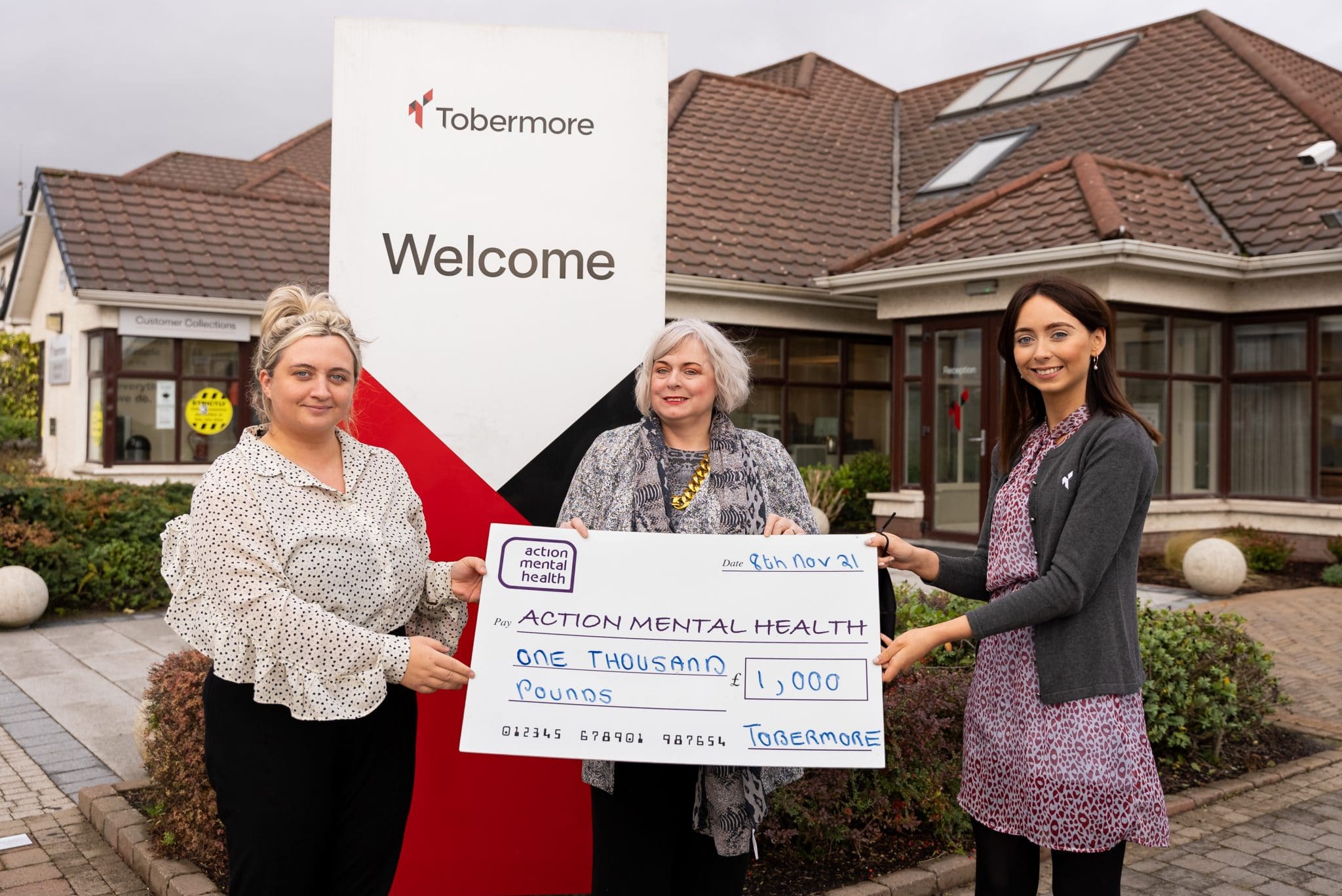Tobermore HR staff presenting Action Mental Health a donation cheque