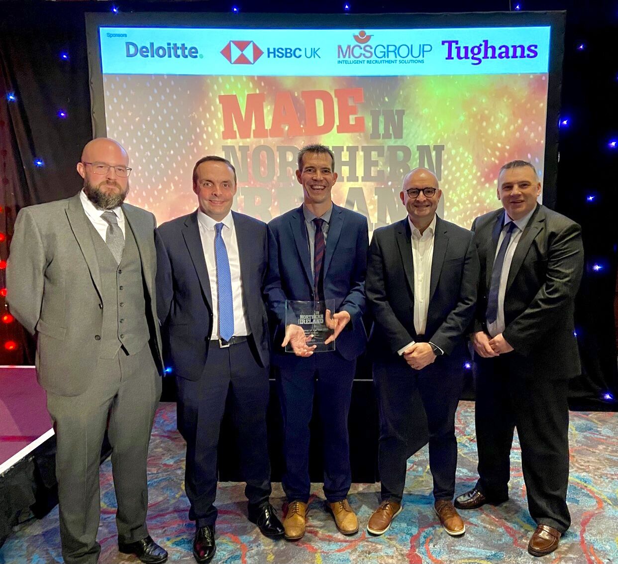 tobermore production staff and glenn robinson general manager with award